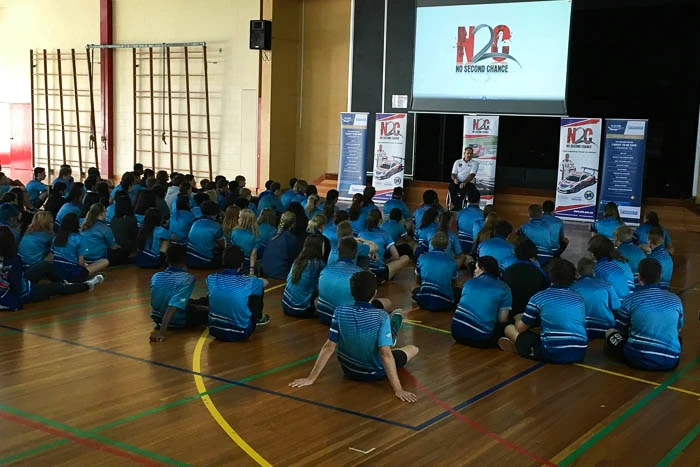 Matt Speakman addresses Palmerston Senior College students from his wheelchair